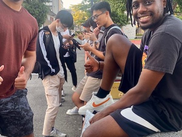 Lake Forest College students Nathaniel Barnes (left) and Thomas Mayiga (right) supervising students completing the survey at Feng Cha University