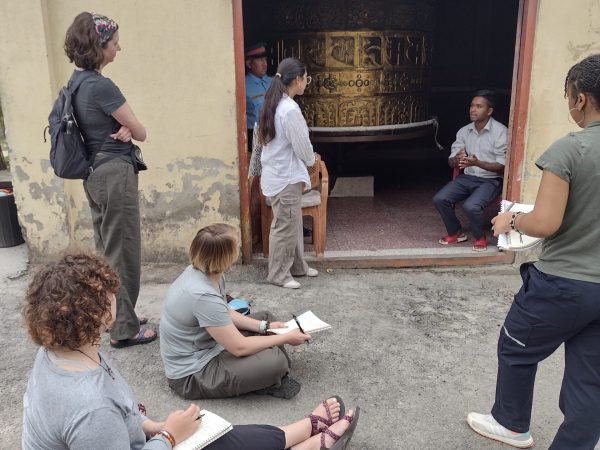 (Left to Right) Delaney Scott, Jordyn Shumpert, Kai Miller, Dr. Perry- Sizemore, and Kusum Tamang interviewing Raju Tamang at Kopan Nunnery about the value of monasticism, nuns, and the nunnery for himself, his daughters, and the broader Kathmandu community.