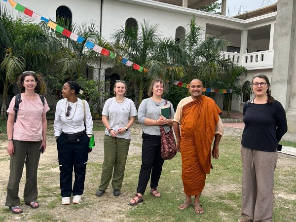 (Left to Right) Dr Liz Perry-Sizemore, Jordyn Shumpert, Kai Miller, Delaney Scott, Venerable Metteyya Sakyaputta (founder of the Lumbini Social Service Foundation), and Dr. Suzanne Bessenger at the Peace Grove Nunnery in the international monastic zone of Lumbini, Nepal.