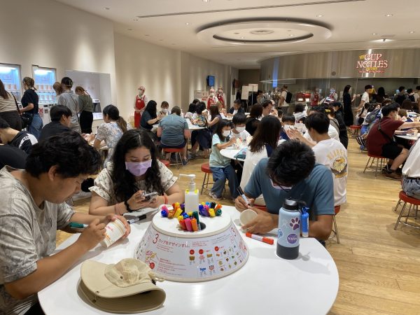 Students making their own unique cup noodles at the Cup Noodle Museum in Yokohama. The cup noodle was invented by a Japanese-naturalized Taiwanese entrepreneur Momofuku Ando, born as Go Pek-Hok in Japanese occupied Chaiyi. The museum obfuscates this colonial background.
